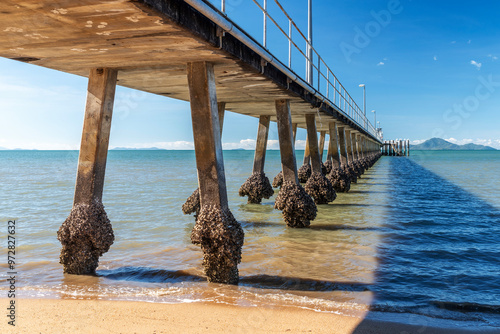 Pier and golden beach in Cardwell town in Queensland, Australia. Cardwell is coastal town and rural locality in Cassowary Coast Region.