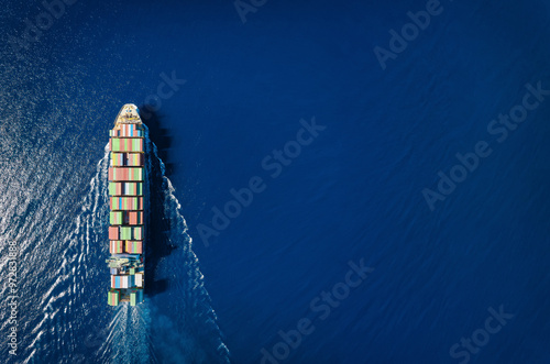 Obraz na płótnie High aerial top view of a commercial container cargo ship in motion with copy space as a concept for transport and industry w salonie