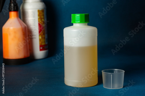 Closeup unlabeled bottle as mockup copy space for herbicide, fungicide or insecticide.