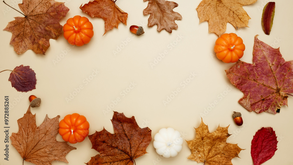 Autumn composition with maple leaves, decorative pumpkins and candles. Top view. Copy space Autumn composition with maple leaves, decorative pumpkins and candles. Top view. Copy space