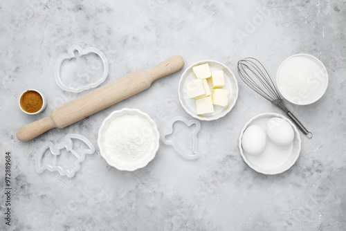 Ingredients for baking Halloween cookies including flour, butter, sugar, spices, eggs. Seasonal autumn baking