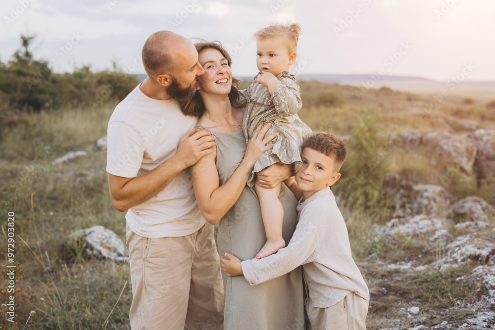 Happy Family Embracing in Nature at Sunset, Parents with Children Celebrating Love and Togetherness Outdoors Happy Family Embracing in Nature at Sunset, Parents with Children Celebrating Love and Togetherness Outdoors