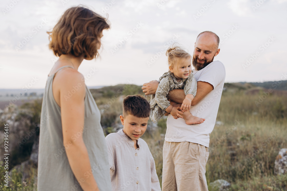 Happy Family Enjoying Time in Nature with Smiling Children and Parents Outdoors Happy Family Enjoying Time in Nature with Smiling Children and Parents Outdoors
