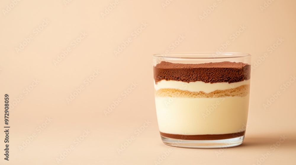 A glass of dessert with a brown topping A glass of dessert with a brown topping