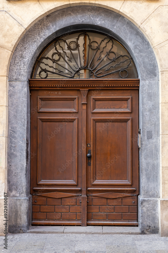 Elegant wooden door with ornate glass design in a historical building in old town Elegant wooden door with ornate glass design in a historical building in old town