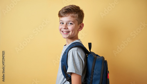 Portrait of a middle school boy with a backpack and a cheerful smile