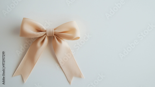 A beautifully lit brown bow, with subtle lighting from below, standing out against a clean white background for a festive look. photo