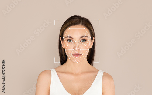 A woman stands calmly as facial recognition technology is applied to analyze her features with a simple background.