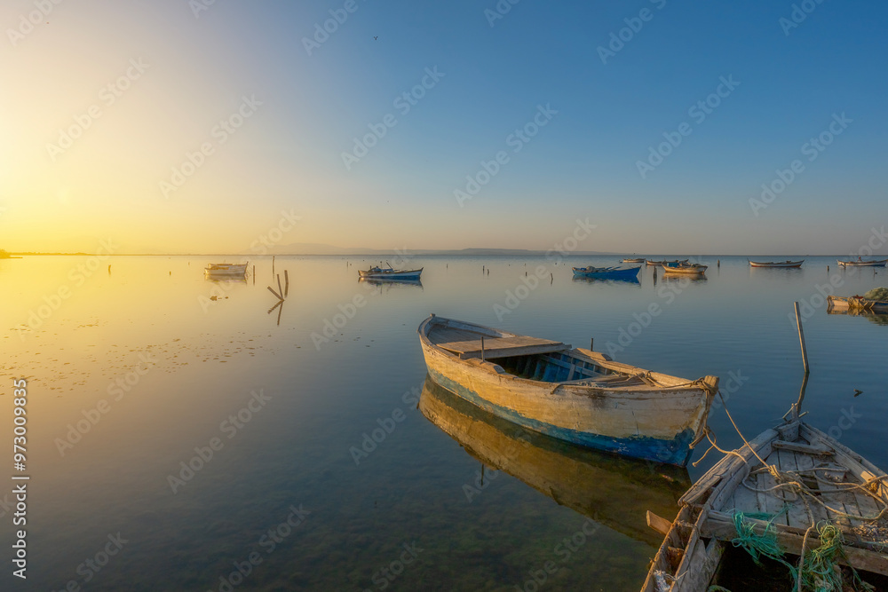 Fishing boats in the Karina region near the Söke district of Aydın province Turkey are heated by sunlight at sunrise Fishing boats in the Karina region near the Söke district of Aydın province Turkey are heated by sunlight at sunrise