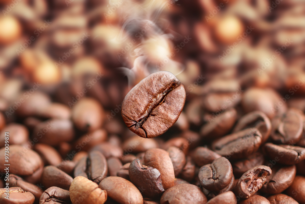 Fototapeta premium Coffee beans close-up with smoke. Roasted coffee beans.