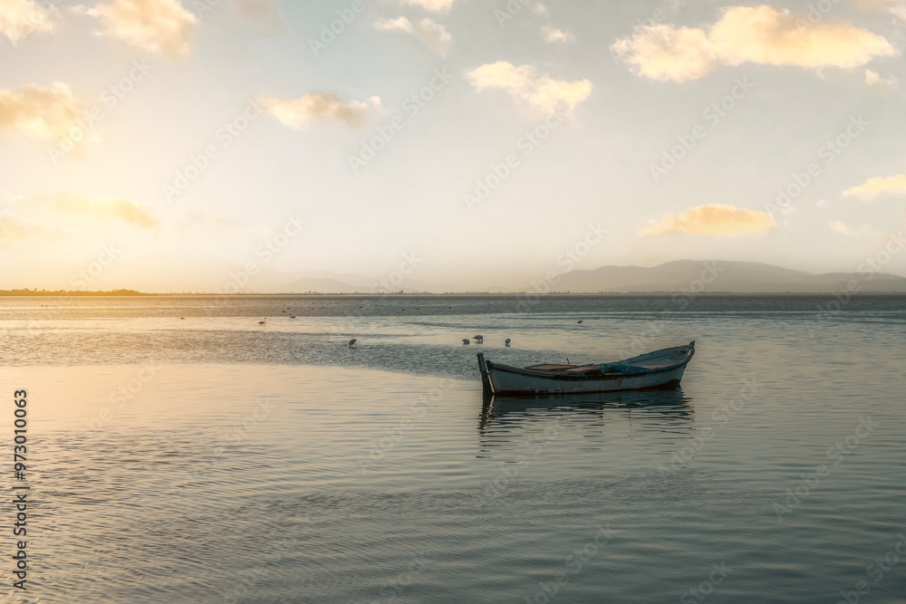 Fishing boats in the Karina region near the Söke district of Aydın province Turkey are heated by sunlight at sunrise Fishing boats in the Karina region near the Söke district of Aydın province Turkey are heated by sunlight at sunrise