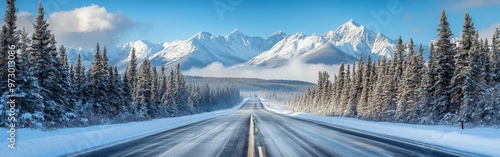 Straight Road Leading to Snowy Mountains Under Clear Blue Skies