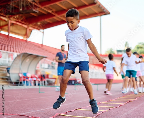 Fototapeta Naklejka Na Ścianę i Meble -  child sport athlete childhood girl competition fun young outdoor active exercise kid running fitness training athletic game healthy group play team school exercising jump