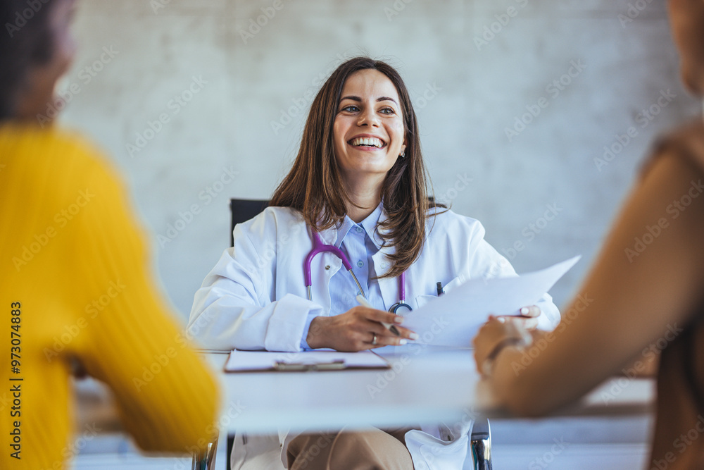 Smiling Doctor Meeting with Patients in a Medical Office Smiling Doctor Meeting with Patients in a Medical Office