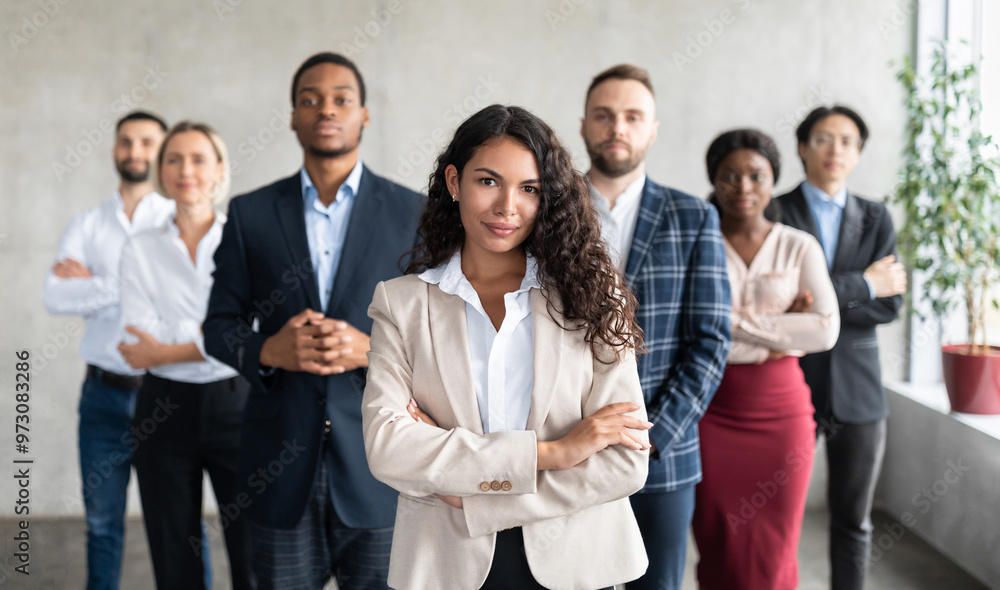 Successful Latin Businesswoman Standing In Front Of Business Team Posing In Modern Office, Smiling To Camera. Female Entrepreneurship And Leadership, Career Growth And Success. Selective Focus Successful Latin Businesswoman Standing In Front Of Business Team Posing In Modern Office, Smiling To Camera. Female Entrepreneurship And Leadership, Career Growth And Success. Selective Focus