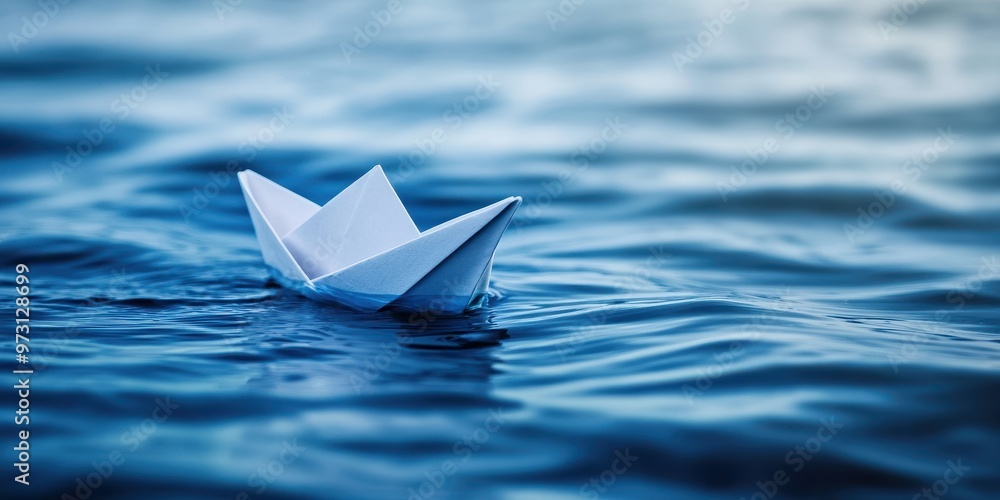 Serenity of Simplicity - Minimalist Paper Boat Floating in Tranquil Blue Water, Conceptual Metaphor for Minimalism and Peaceful Living Serenity of Simplicity - Minimalist Paper Boat Floating in Tranquil Blue Water, Conceptual Metaphor for Minimalism and Peaceful Living
