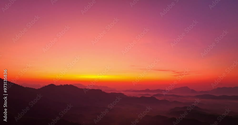aerial view A serene landscape capturing the soft hues of dawn as mist settles over distant mountain ranges under a pastel-colored sky. Amazing pink sky at sunrise. gradient color sky texture aerial view A serene landscape capturing the soft hues of dawn as mist settles over distant mountain ranges under a pastel-colored sky. Amazing pink sky at sunrise. gradient color sky texture