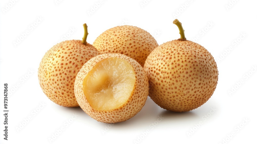 Four round, speckled fruits with one sliced open, revealing a light-colored interior. Four round, speckled fruits with one sliced open, revealing a light-colored interior.
