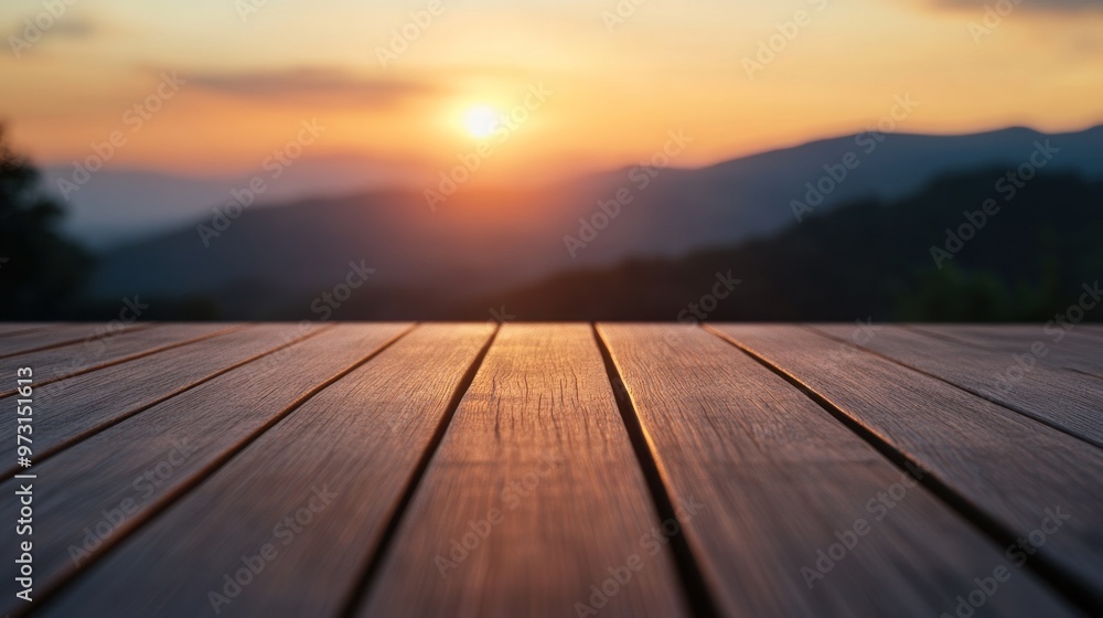 A serene sunset over mountains, viewed from a wooden deck. A serene sunset over mountains, viewed from a wooden deck.
