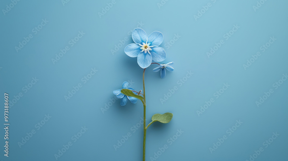 Obraz premium A delicate blue flower with vibrant petals and green leaves, set against a soft blue background, symbolizing tranquility and beauty.