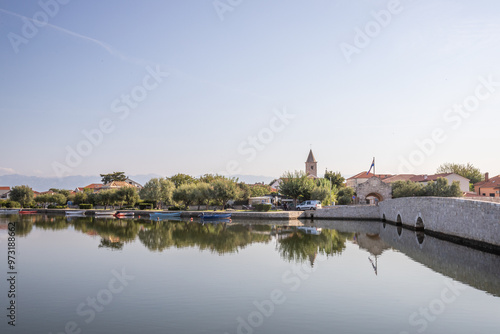 Skyline of a small Mediterranean town, historic city center with massive city walls on an island in a bay or lagoon. Morning mood in Nin, Zadar, Dalmatia, Croatia, Adriatic