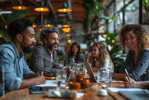 Young professionals collaborating on a project, enjoying the vibrant atmosphere of a modern cafe while working on their laptops