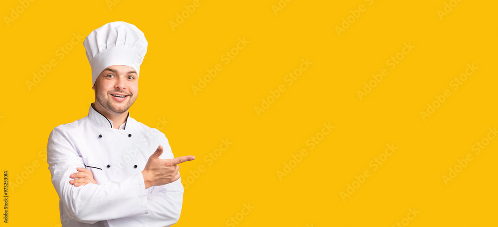 Look There. Male Chef Pointing Fingers Aside Standing On Yellow Studio Background. Panorama, Free Space For Text Look There. Male Chef Pointing Fingers Aside Standing On Yellow Studio Background. Panorama, Free Space For Text