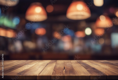 Empty wood table top on abstract blurred game center shop and nightclub lights background