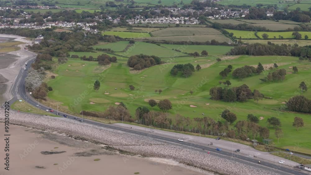 Aerial view of golf course in the United Kingdom next to a beach. Sports and recreation concept