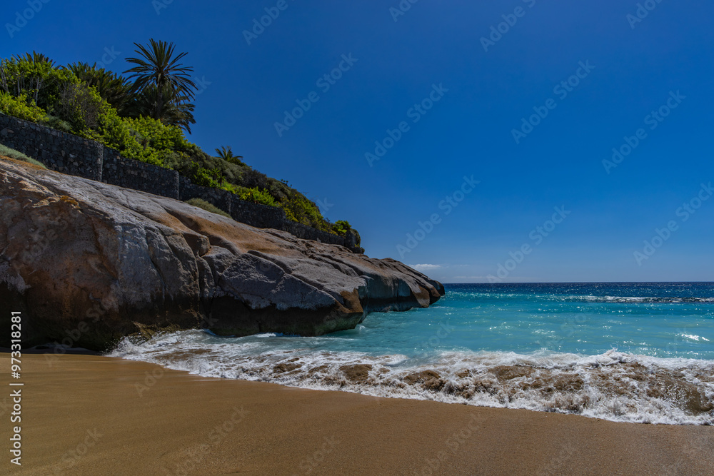 Fototapeta premium Yellow sand beach, dangerous high waves, rough Atlantic Ocean, famous Playa del Duque Teneriffe Costa Adeje