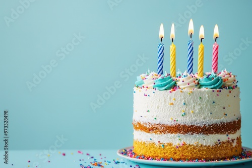 Birthday cake with six candles on a pastel blue background, with space for text.