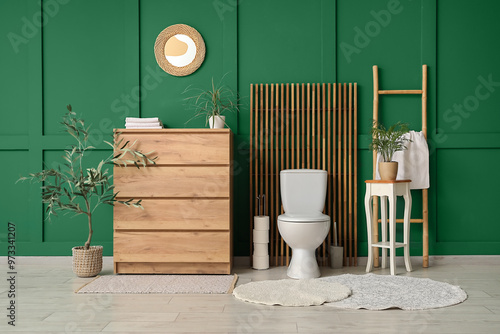 Interior of restroom with toilet bowl, commode and table