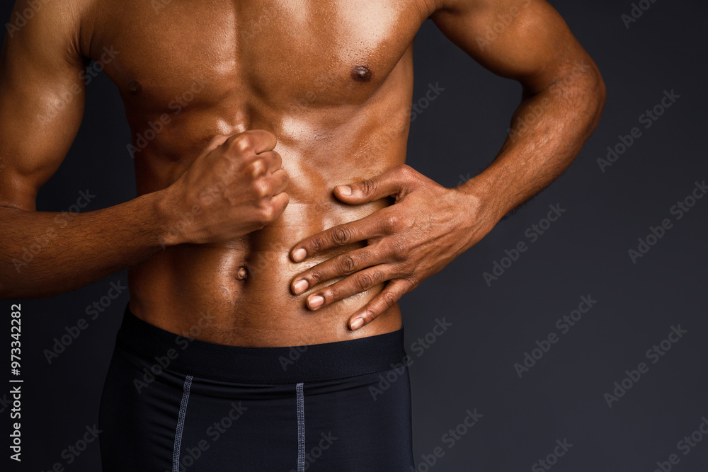 Naked Torso. Unrecognizable black man showing muscular body and six pack abs over black background with copyspace Naked Torso. Unrecognizable black man showing muscular body and six pack abs over black background with copyspace