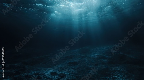 Underwater view of the dark blue ocean surface, evoking depth and mystery.