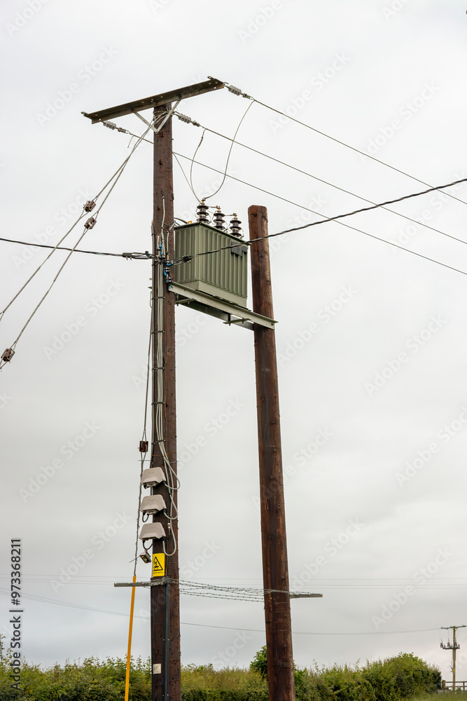 Electricity supply transformer and distribution power lines on wooden telegraph poles in rural Ayrshire Scotland Electricity supply transformer and distribution power lines on wooden telegraph poles in rural Ayrshire Scotland