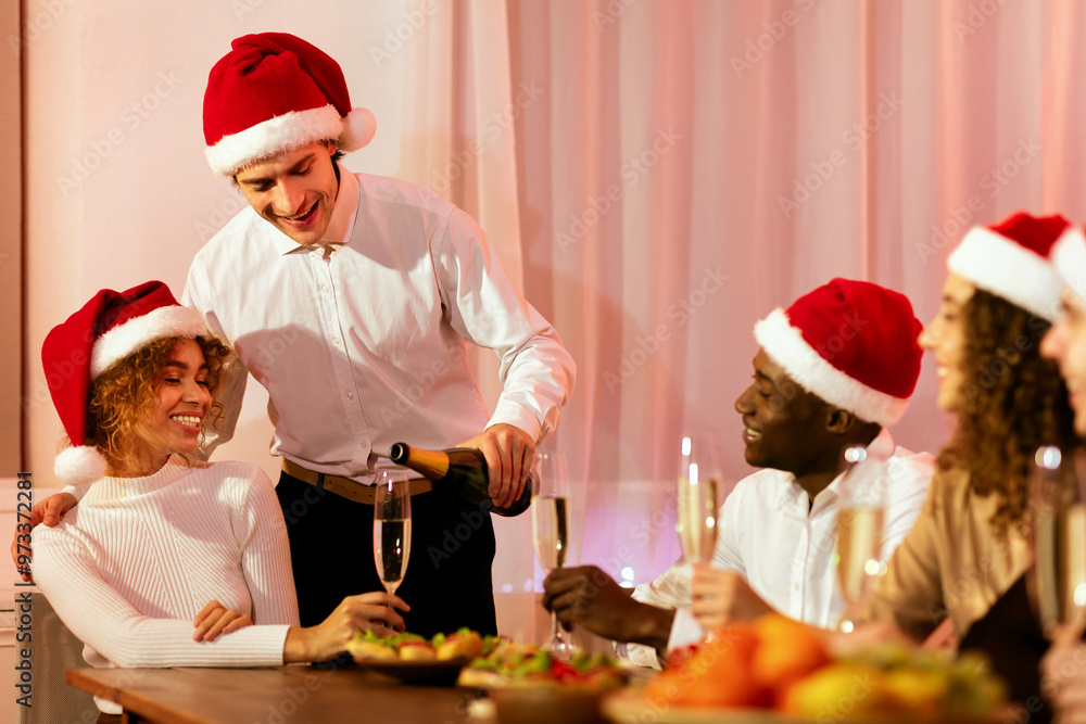 Christmas Eve. Man Serving Champagne Filling Glasses Celebrating Xmas With Friends At Home Christmas Eve. Man Serving Champagne Filling Glasses Celebrating Xmas With Friends At Home