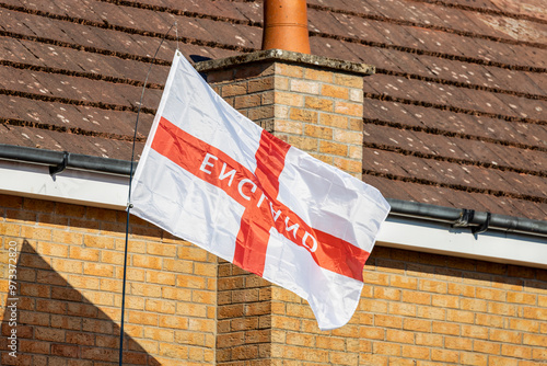 England red cross on white background flag flying upside down on brick house
