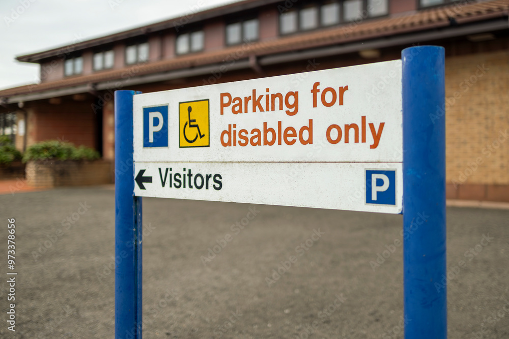 Parking for disabled only and visitors sign outside medical centre Parking for disabled only and visitors sign outside medical centre