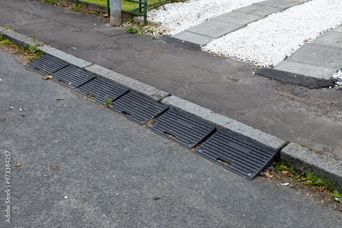 Six rubber kerb ramps at end of domestic driveway onto public road