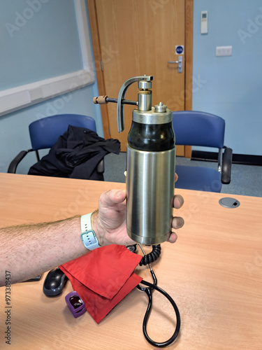 Medical practitioner holding Liquid Nitrogen (LN2) Spray Jet Dispenser used to remove warts and skin lesions photo