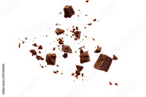 Broken chocolate pieces on white background.Chocolate chips . Ingredients for dessert recipes.Recipe magazines and cookbooks 