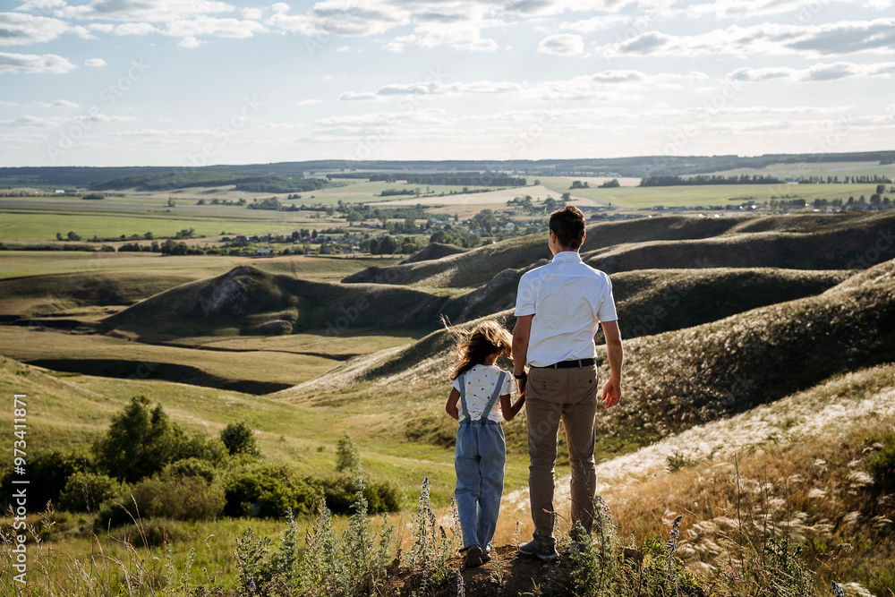 A father and daughter share a beautiful bonding experience amidst a stunning scenic landscape, creating a joyful moment in natures warm embrace A father and daughter share a beautiful bonding experience amidst a stunning scenic landscape, creating a joyful moment in natures warm embrace