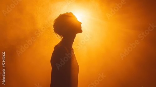 confidence portrayed by a silhouette standing tall under a radiant light, embodying self-assurance and strength photo