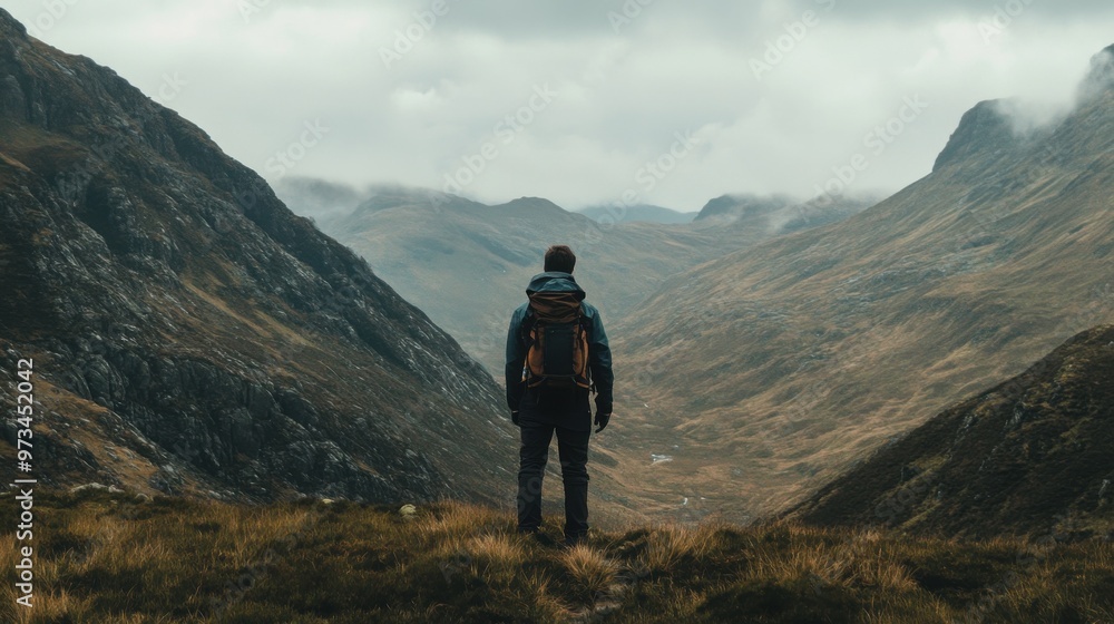 A Hiker Gazing at a Majestic Mountain Valley A Hiker Gazing at a Majestic Mountain Valley