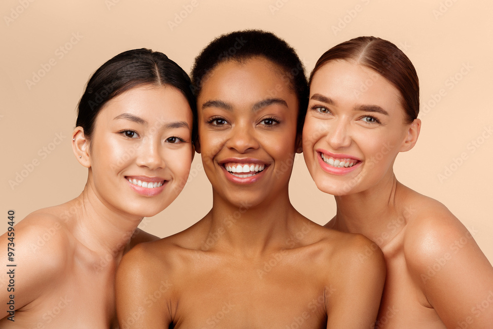 Skin And Body Care. Three Multicultural Ladies Models Posing Smiling At Camera On Beige Studio Background Skin And Body Care. Three Multicultural Ladies Models Posing Smiling At Camera On Beige Studio Background