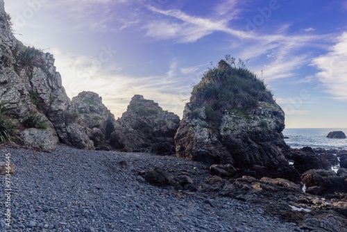 Giant rocks on stoney shoreline in Tawharanui, Warkworth, Auckland, New Zealand. photo