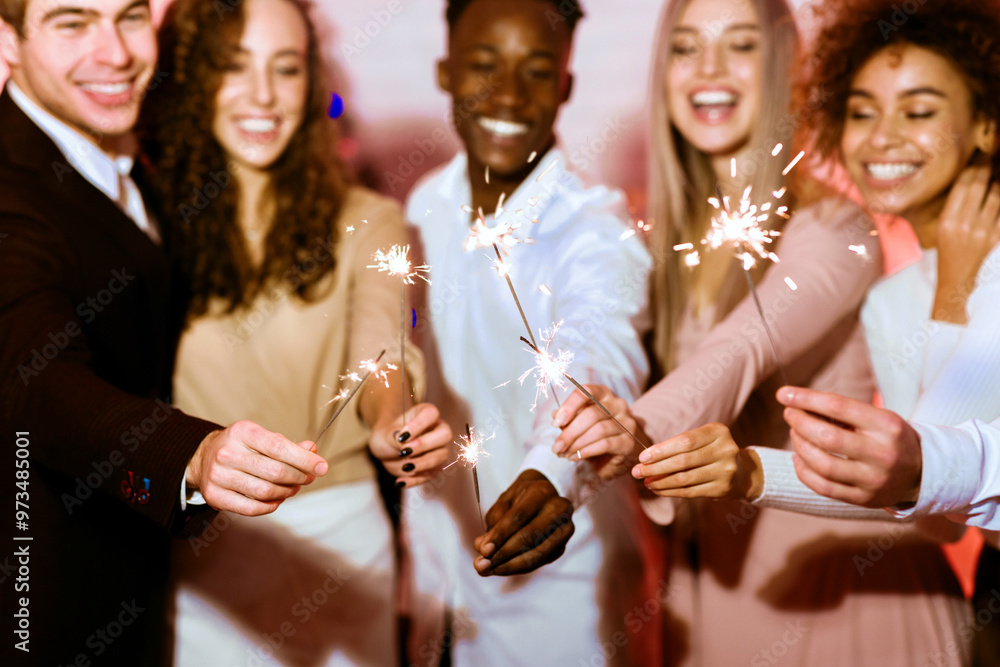 New Year Celebration. Happy Young People Holding Bengal Lights Sparklers Having Party Celebrating Winter Holidays Standing Indoor. New Year Celebration. Happy Young People Holding Bengal Lights Sparklers Having Party Celebrating Winter Holidays Standing Indoor.