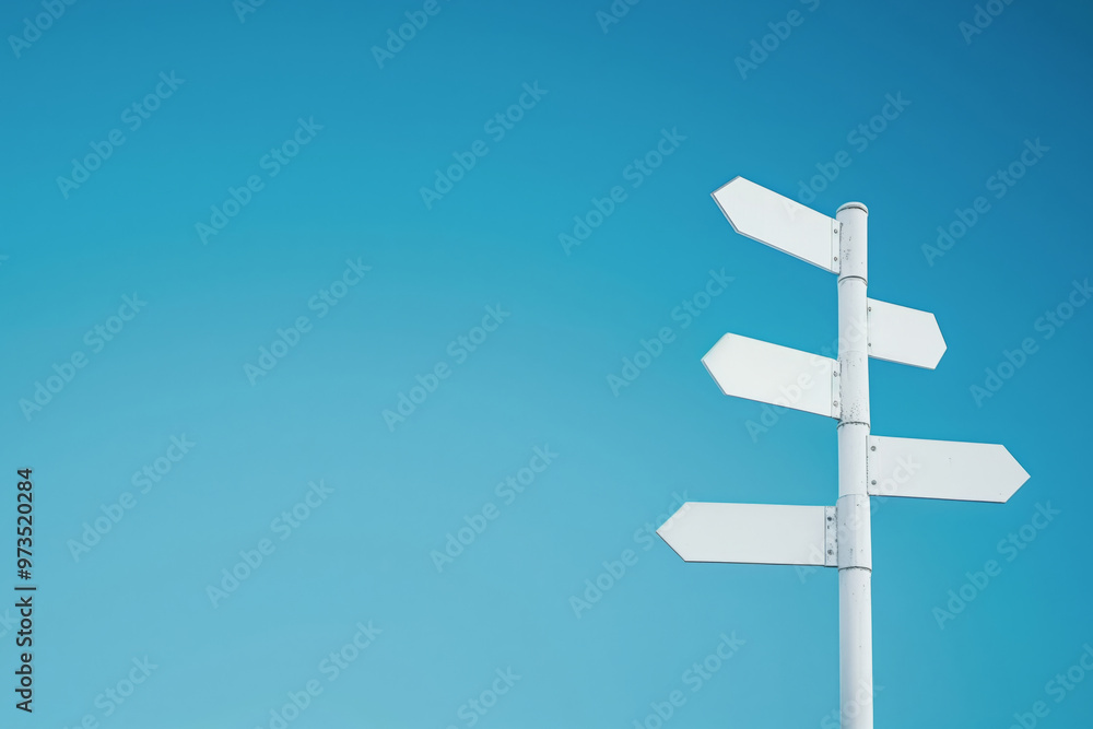 Minimalistic white signpost against clear blue sky with empty, blank copy space for text. Minimalistic white signpost against clear blue sky with empty, blank copy space for text.