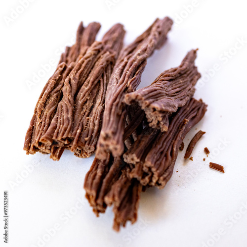 Milk chocolate pieces in the sahape of sticks in white background. photo