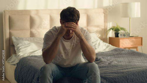 Tableau sur toile Unhappy Caucasian European man holding head problem crisis breakup male guy bedr